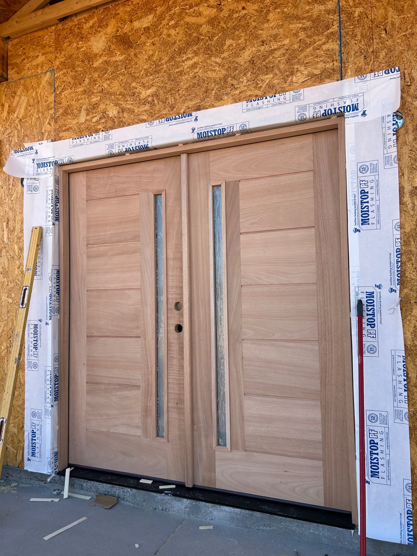 New double door installation with weatherproofing
